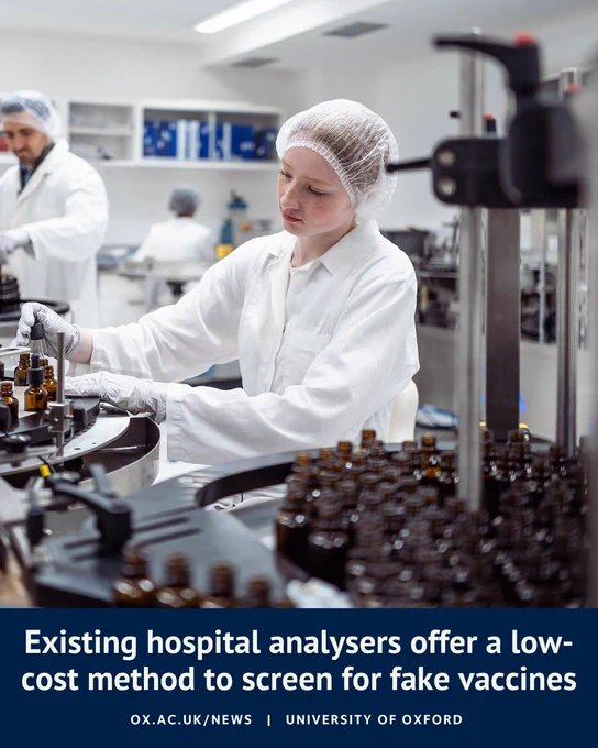 A laboratory technician in a white coat, hair net and gloves operates a hospital analyser, handling small brown glass vials on a circular testing machine. Rows of similar vials are arranged in the foreground, with another staff member working in the background. Overlaid text reads: “Existing hospital analysers offer a low-cost method to screen for fake vaccines” and “ox.ac.uk/news | University of Oxford”.