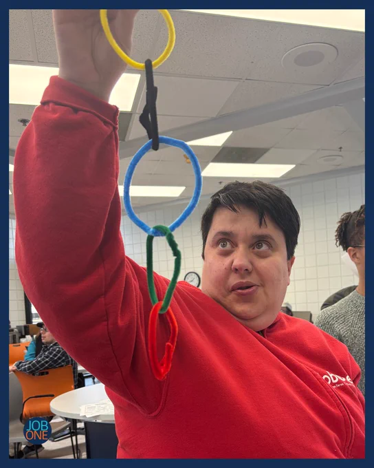 Michelle is holding up Olympic rings she crafted