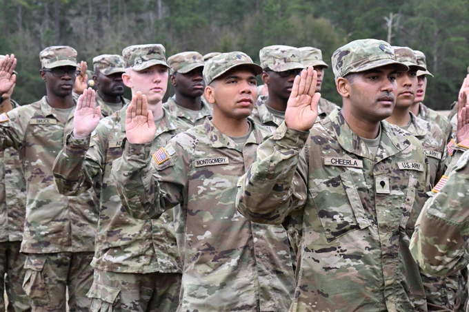 Graduating Soldiers with the 1st Battalion, 13th Infantry Regiment recite the Oath of Enlistment as part of the Soldier Induction Ceremony on Family Day at the U.S. Army Training Center, February 18 at Fort Jackson, SC.