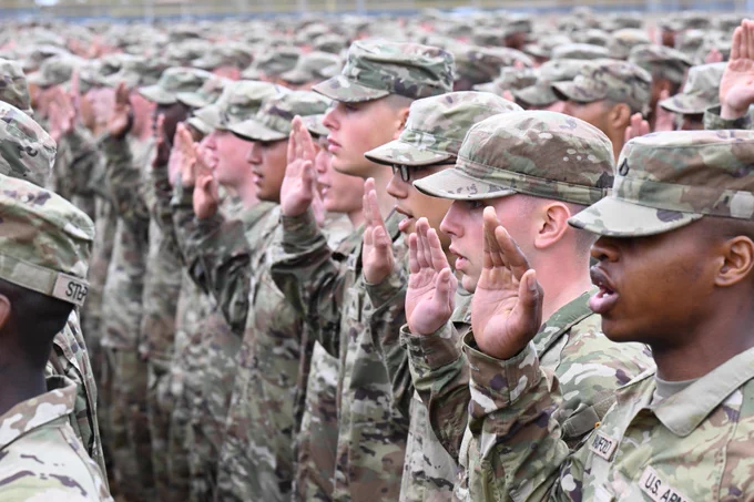 Graduating Soldiers with the 1st Battalion, 13th Infantry Regiment recite the Oath of Enlistment as part of the Soldier Induction Ceremony on Family Day at the U.S. Army Training Center, February 18 at Fort Jackson, SC.