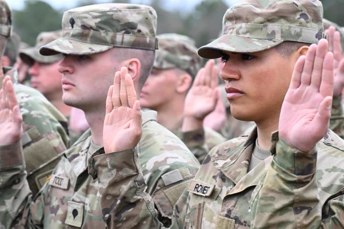 Graduating Soldiers with the 1st Battalion, 13th Infantry Regiment recite the Oath of Enlistment as part of the Soldier Induction Ceremony on Family Day at the U.S. Army Training Center, February 18 at Fort Jackson, SC.