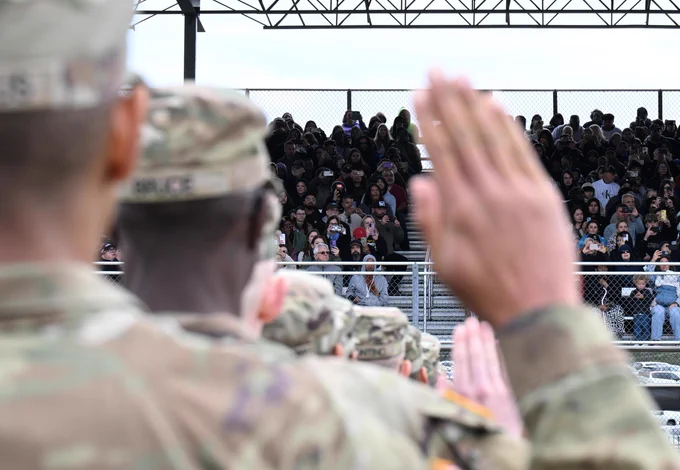 Graduating Soldiers with the 1st Battalion, 13th Infantry Regiment recite the Oath of Enlistment as part of the Soldier Induction Ceremony on Family Day at the U.S. Army Training Center, February 18 at Fort Jackson, SC.