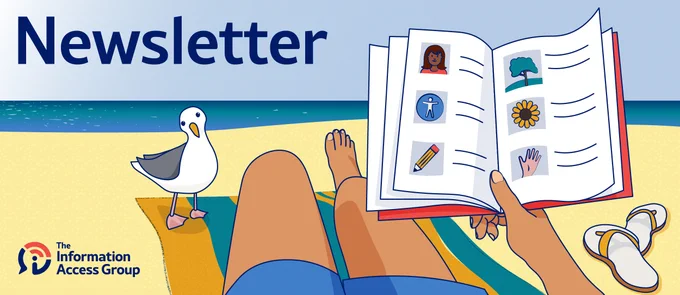 A beach scene from the point of view of the person sitting on the beach, looking towards the water. There is a yellow and blue striped towel laid out on the sand. There are 2 legs stretched out on the towel. A hand is holding up a red book with pages open to Easy Read images and text. There are a pair of yellow thongs on the sand to the right of the person. There is a seagull standing on the left corner of the towel. It is looking at the person with curiosity. 