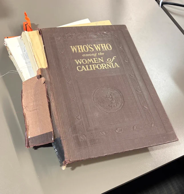 brown cloth covered book with yellow font for title "Who's Who among the Women of California." the spine is torn away, revealing the binding and that the pages are separated into two chunks. 