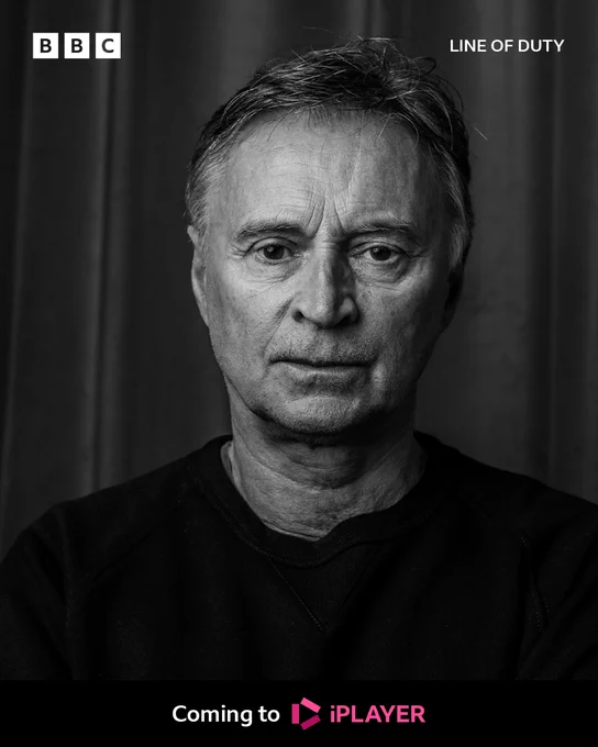 A black and white head and shoulders shot of a man in a dark top (Robert Carlyle), looking to camera.