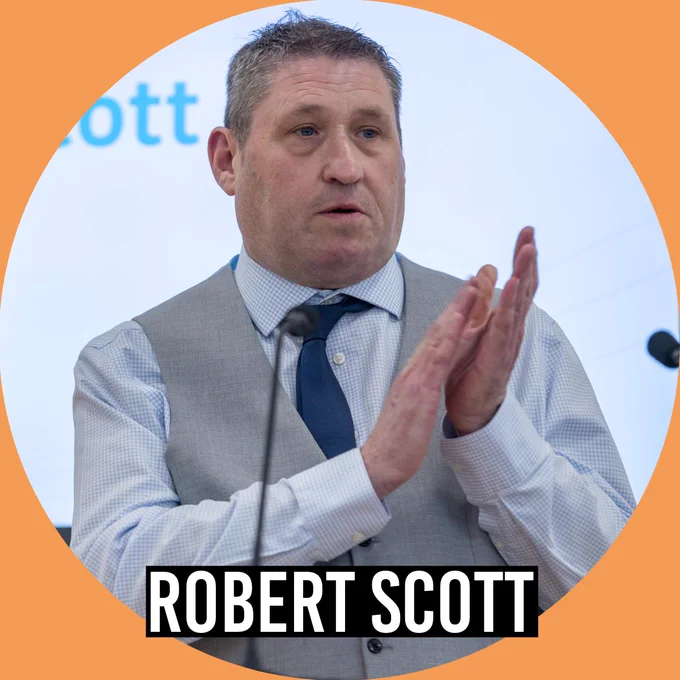 Portrait of  Robert Scott on a panel wearing a suit. The image is framed in an orange circle with the name “Robert Scott” displayed at the bottom.