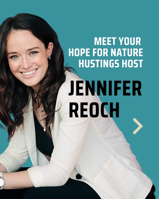 A woman with long dark hair is smiling and leaning slightly to the side, wearing a white blazer over a black top. The teal background has bold white text saying, "Meet your Hope For Nature Hustings host Jennifer Reoch," with an arrow pointing right.