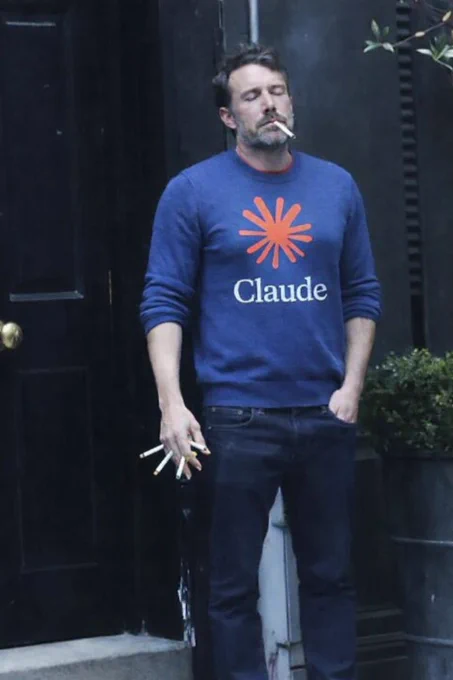 photo of a Ben in a blue sweater with the Claude logo, holding multiple cigarettes and one loosely in his mouth