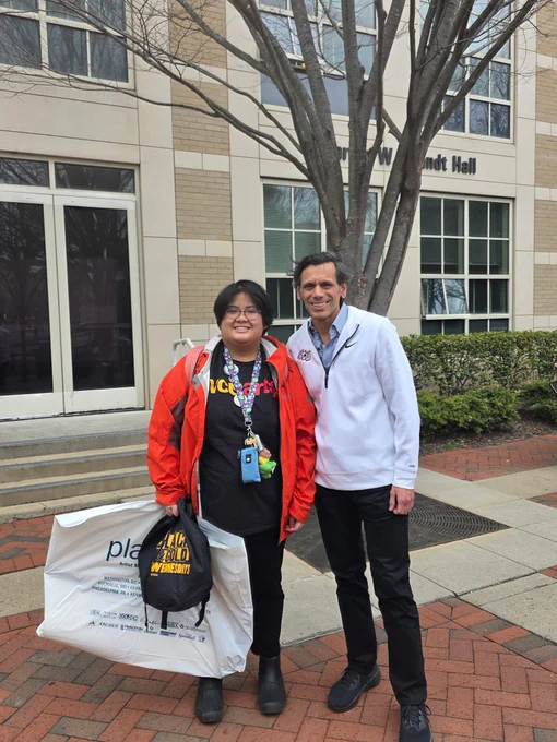 Dr. Rao poses with a student in a V-C-U Arts shirt outside of Brandt Hall.