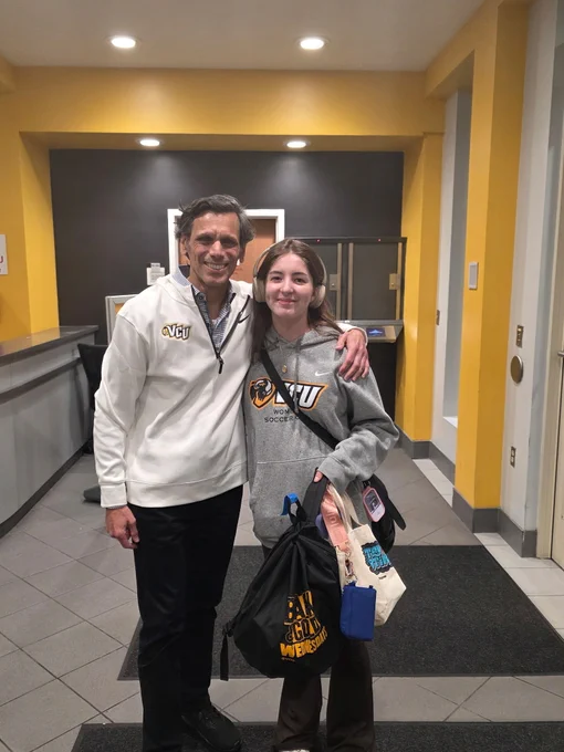 Dr. Rao poses with a student wearing a V-C-U Women's Soccer hoodie.