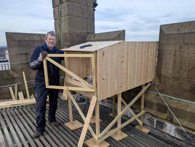 A peregrine falcon nest box under construction on the tower roof of Derby Cathedral, England.