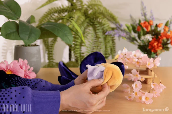 A photo of someone in the process of reversing the Player Character plush in a bright, airy room; a second design is hidden on the inside. 
