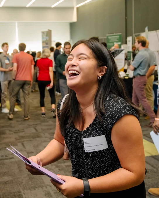 An NC State student laughing at Career Connections.