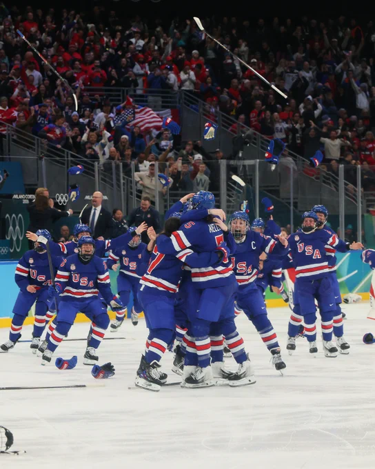 Photo of Team USA women's ice hockey celebrating. 