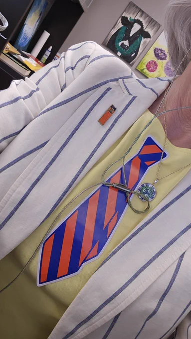 Picture of a person wearing an orange and blue striped tie