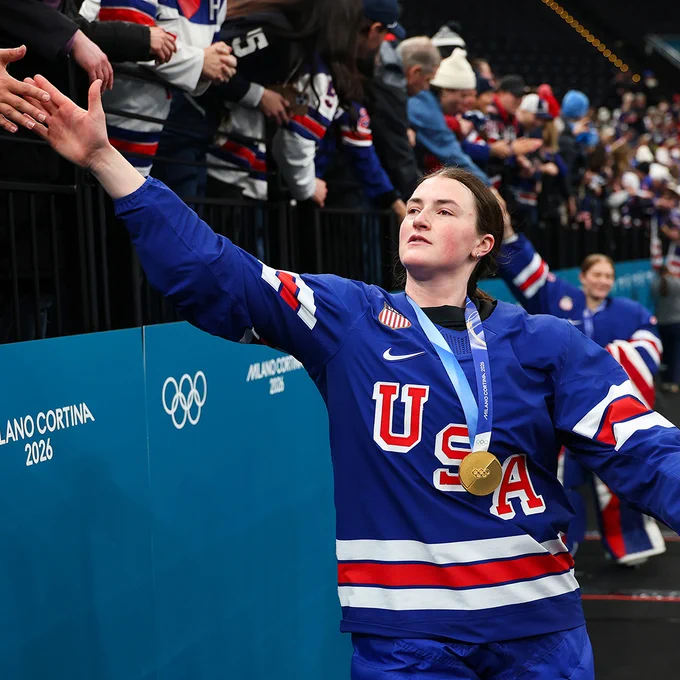 MILAN, ITALY - FEBRUARY 19: Rory Guilday #6 of Team United States high fives with fans after the medal ceremony for the Ice Hockey Women following the Women's Gold Medal match between the United States and Canada on day 13 of the Milano Cortina 2026 Winter Olympic games at Milano Santagiulia Ice Hockey Arena on February 19, 2026 in Milan, Italy. (Photo by Gregory Shamus/Getty Images)