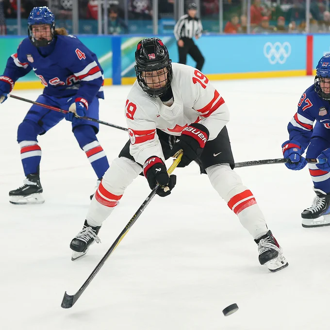 MILAN, ITALY - FEBRUARY 19: Brianne Jenner #19 of Team Canada controls the puck against Abbey Murphy #37 of Team United States in the third period during the Women's Gold Medal match between the United States and Canada on day 13 of the Milano Cortina 2026 Winter Olympic games at Milano Santagiulia Ice Hockey Arena on February 19, 2026 in Milan, Italy. (Photo by Gregory Shamus/Getty Images)