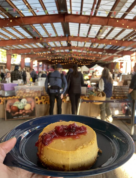 A pastry with red sauce sits on a blue plate, a market is seen in the distance.  Picture by Chantal Stepa. 