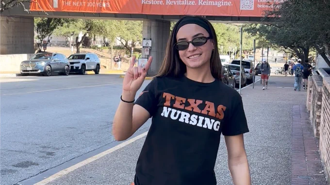 Student wearing burnt orange on campus on Longhorn Friday