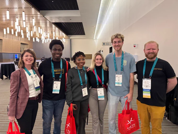 Six conference attendees pose for a picture.
