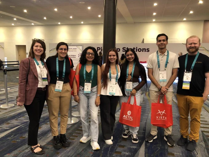Seven conference attendees pose for a picture.