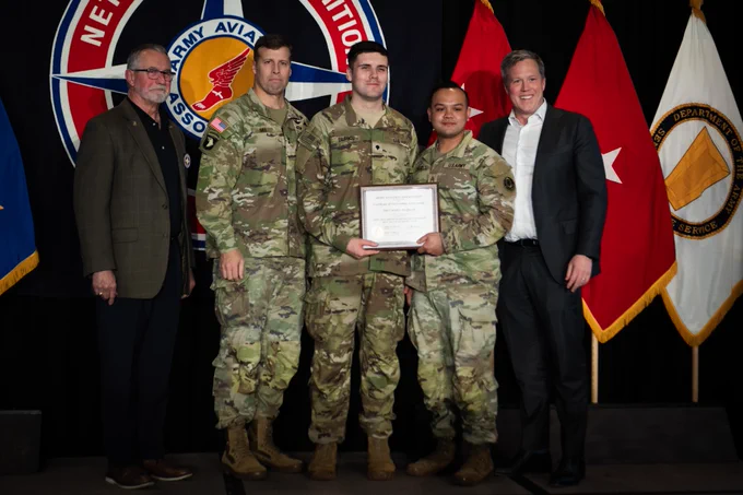 Secretary of the Army poses with Best Drone winners.