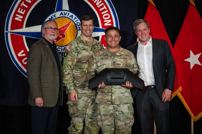 Secretary of the Army poses with Best Drone winners.
