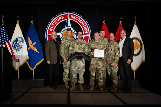 Secretary of the Army poses with Best Drone winners.