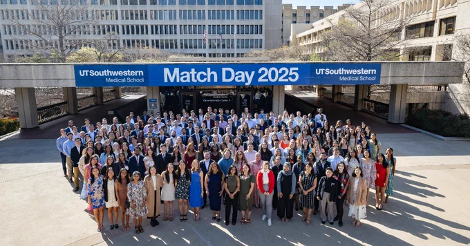 Large group of students standing together in a courtyard with a banner above them that says "Match Day 2025."