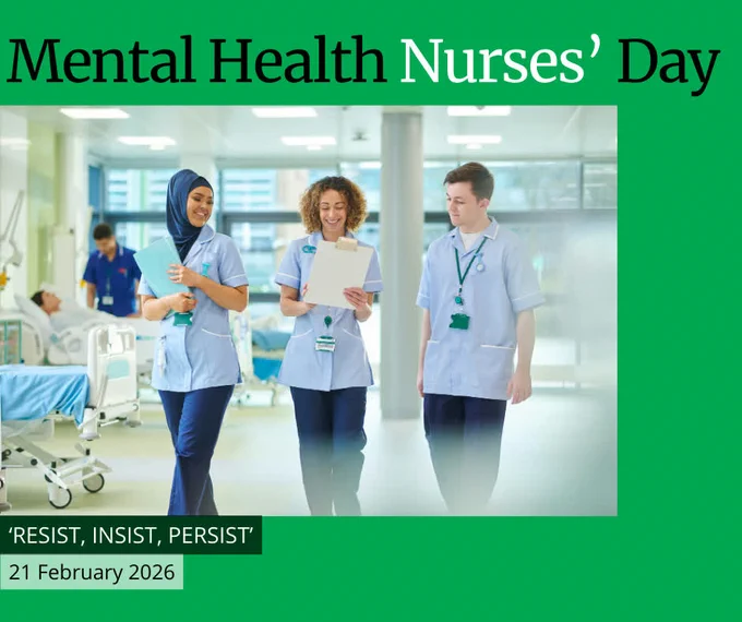 Photo of 3 nurses in scrubs walking through the ward of a hospital, holding charts and paperwork, chatting with each other.