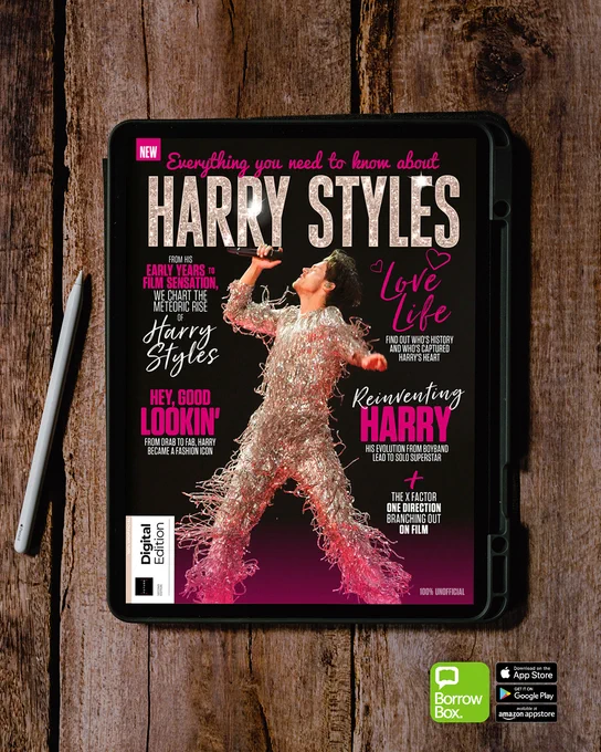 Digital magazine cover on a tablet featuring Harry Styles in a sparkling outfit mid-performance against a dark background.