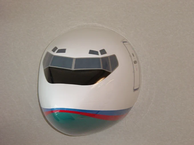 Small airplane nose hung on a wall.