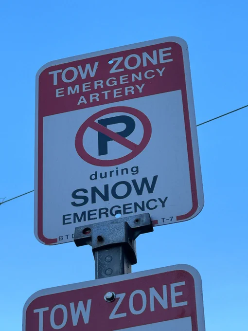 A sign posted in the City of Boston that reads: "Tow Zone Emergency Artery. No Parking during Snow Emergency"