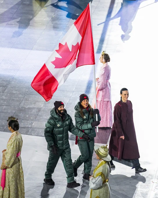Team Canada’s flag-bearers Steven Dubois and Valérie Maltais walk into the Verona Olympic Arena for the closing ceremony of the Milano Cortina 2026 Olympic Winter Games in Italy on Sunday, February 22, 2026. Photo by Candice Ward/COC.