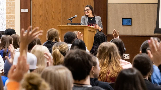 Brooke Mullen of Sapahn smiles while giving the keynote speech at the TMFD Expo while some students in the audience raise their hands