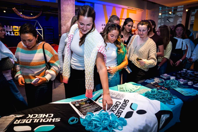 Local college student-athletes grab giveaways from Shoulder Check.