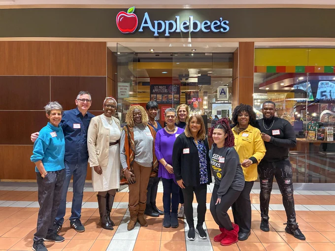 Group photo of VISIONS Brooklyn Advisory Board standing in front of Applebee's