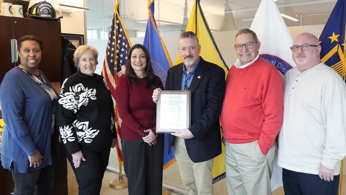 Group photo including Amy Mouro of the DC Fire and EMS Foundation and Jon Greene, ASPR Deputy Assistant Secretary for Response with the plaque.