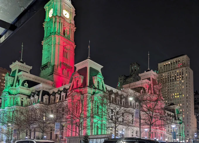 City Hall lit up in red and green