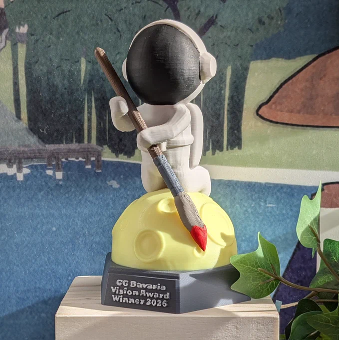 Vision Award statue: astronaut on a moon holding a brush