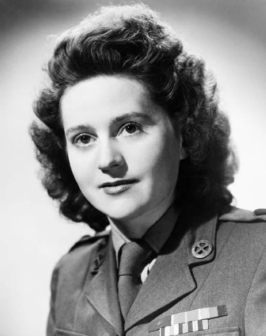 A person in a military uniform is shown in a black and white portrait. The uniform has a star insignia and several medals.
