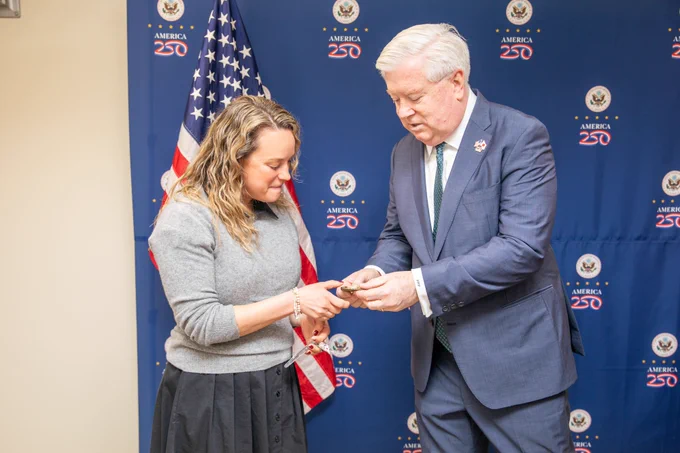 Ambassador Glass gives Julz a coin