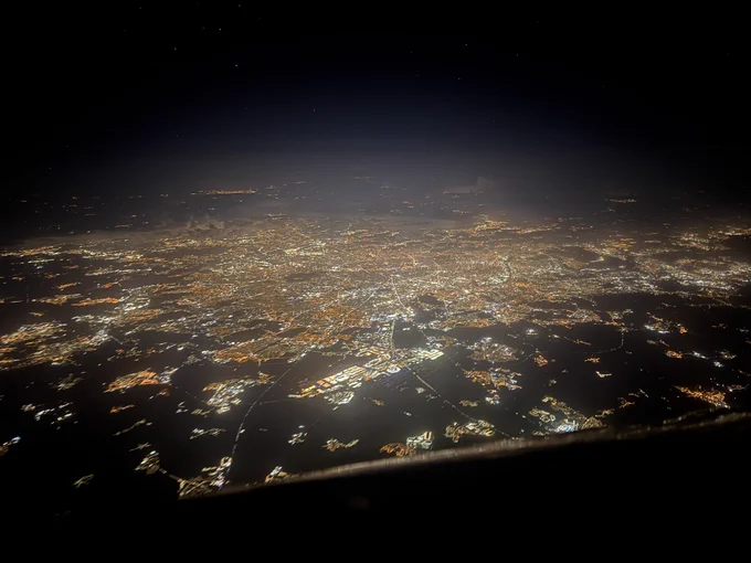 Full city view of Paris at night, with the Charles de Gaulle airport closest to us.