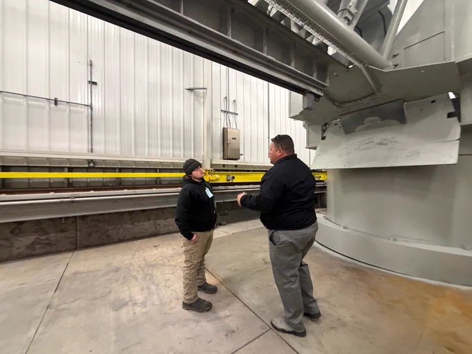 A NASA Wallops employee speaks with a student