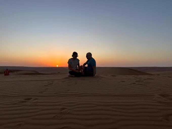 Us at sunset in a desert camp in Oman