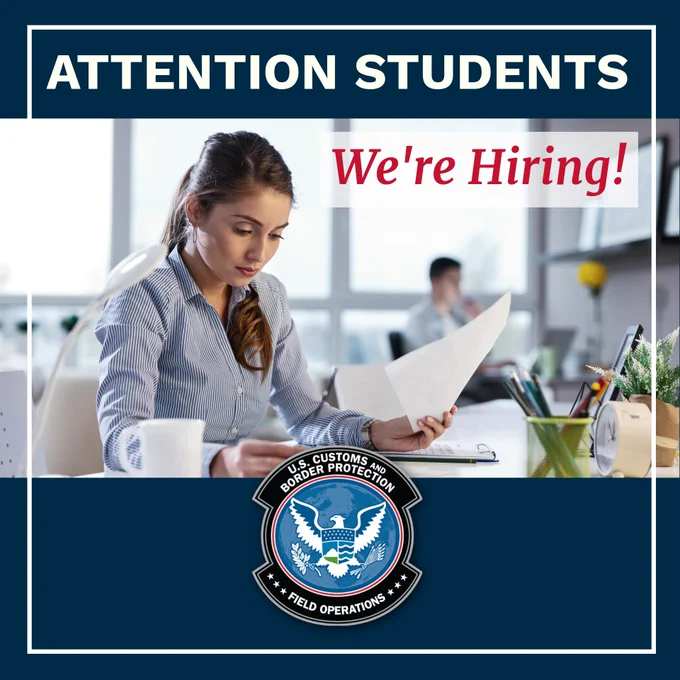 A young woman analyzing documents in a modern workspace. Attention Students, We're Hiring!