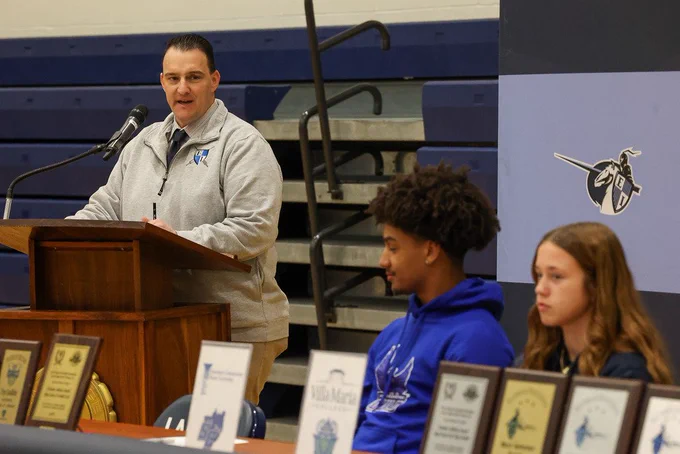 AD talks a mic stand about students
