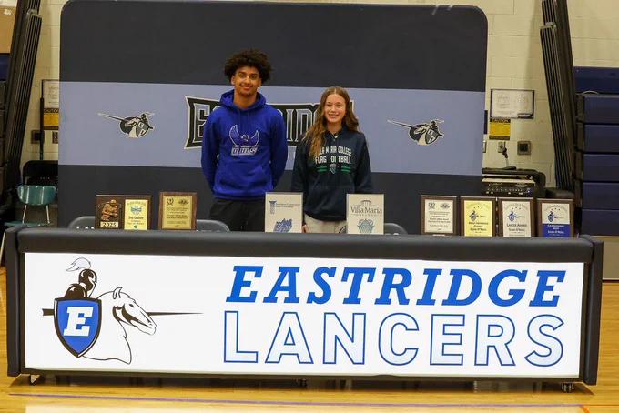 students stand for photo in front of eastridge lancers sign