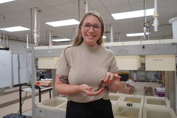 a woman holding a crawfish