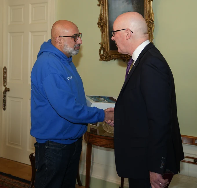 First Minister John Swinney receives cake from Islamic Relief. 